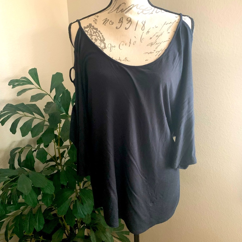 Black blouse highlighting the shoulders and arms with open design